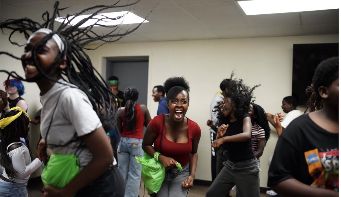 Young women dancing during an indoor worship session