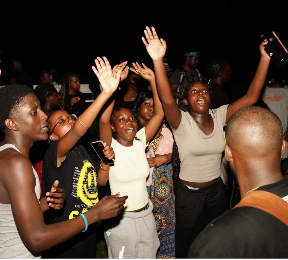 Youth worshipping with hands raised during an evening session
