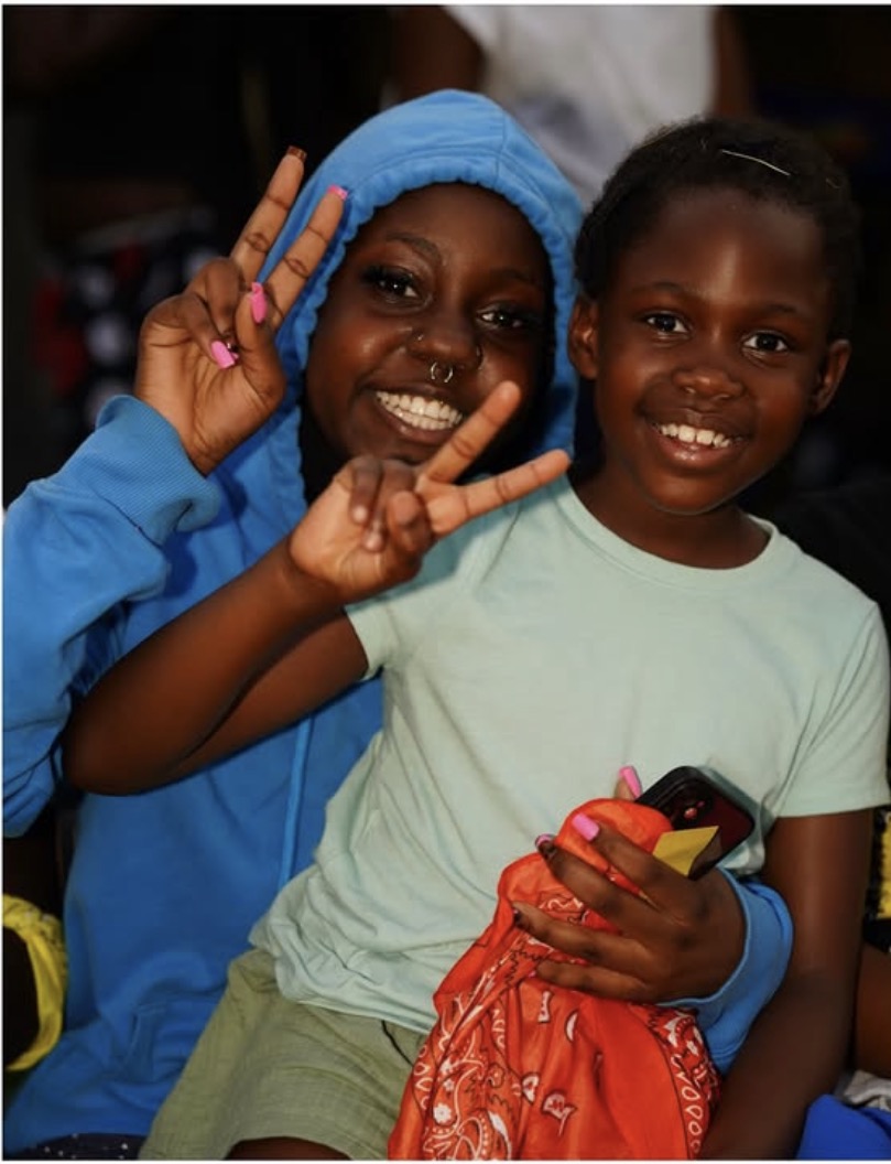 Two young campers posing together for a photo